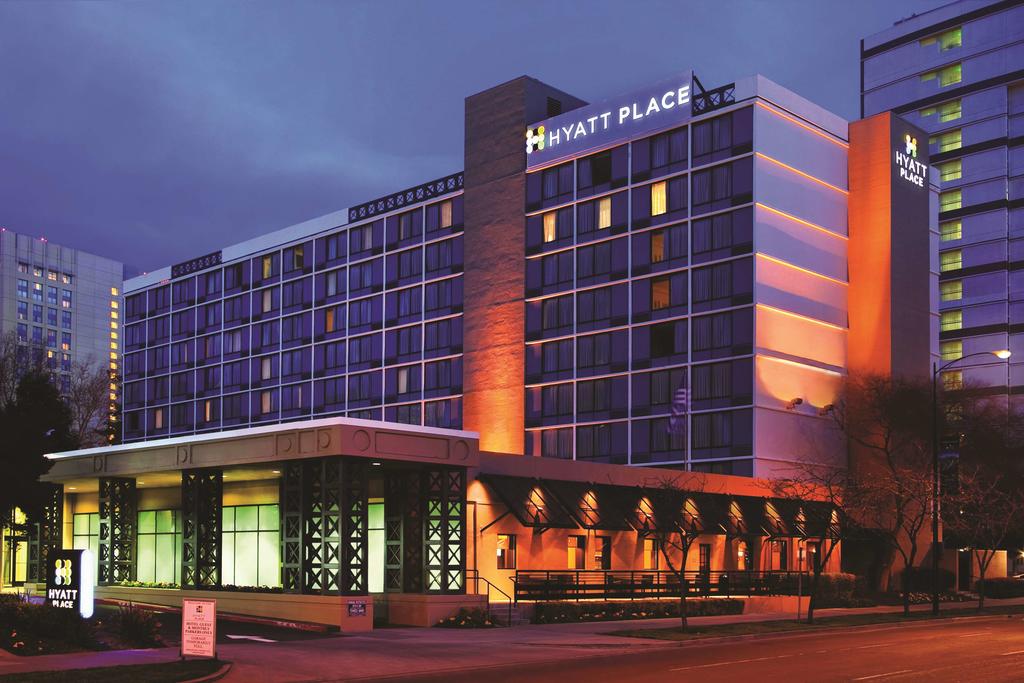 A Hyatt Place property at night, with colorful accent lighting.